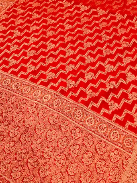 Attractive Red Color Georgette Designer Saree With Flower Motifs And Fancy Tassels