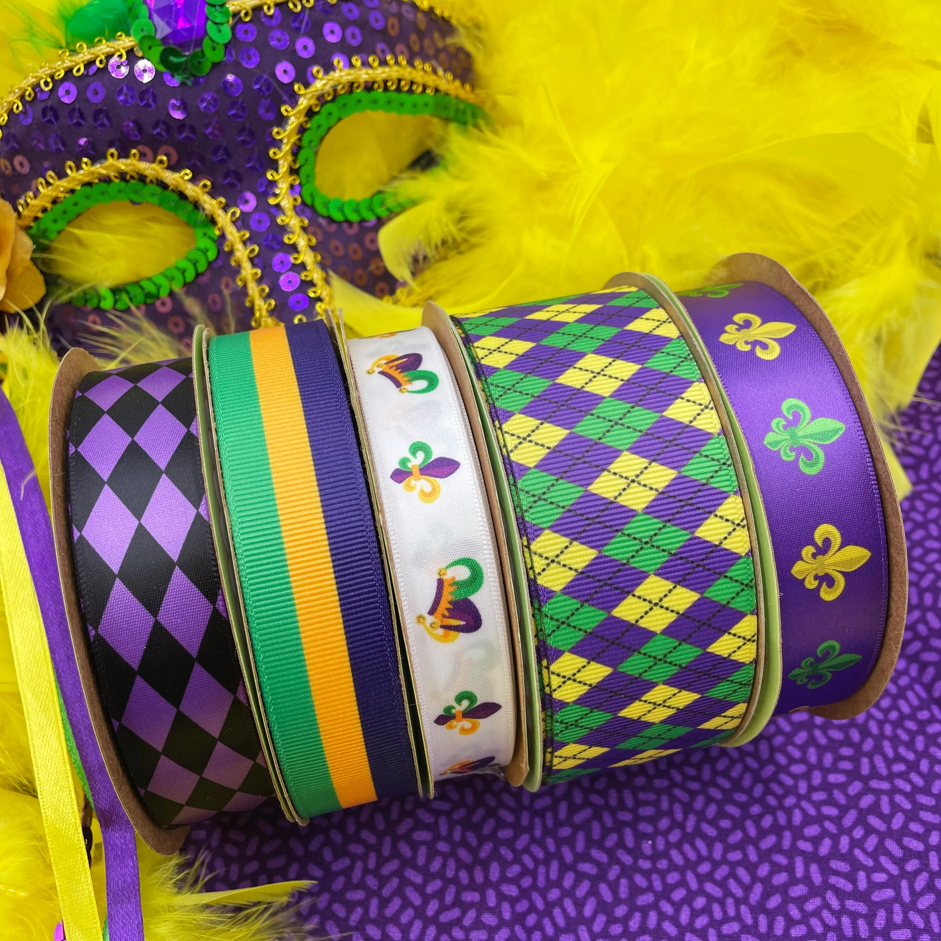 Mardi Gras ribbon with French fleur de lIs in green and yellow on a purple background printed on 7/8" white single face satin